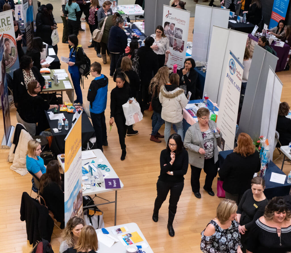 Students walk through a personal support worker career fair.