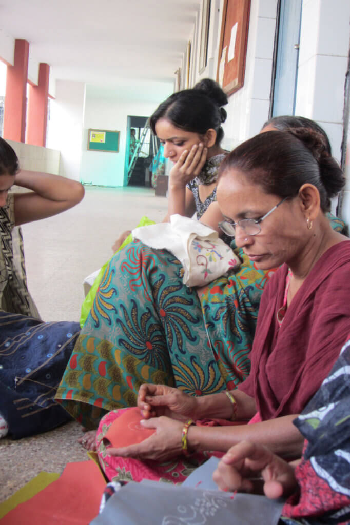 Women embroider at St. Mary's Mahila Shikshan Kendra in India. They’re able to work from home, but twice-weekly trips to St. Mary’s lead to welcome socializing