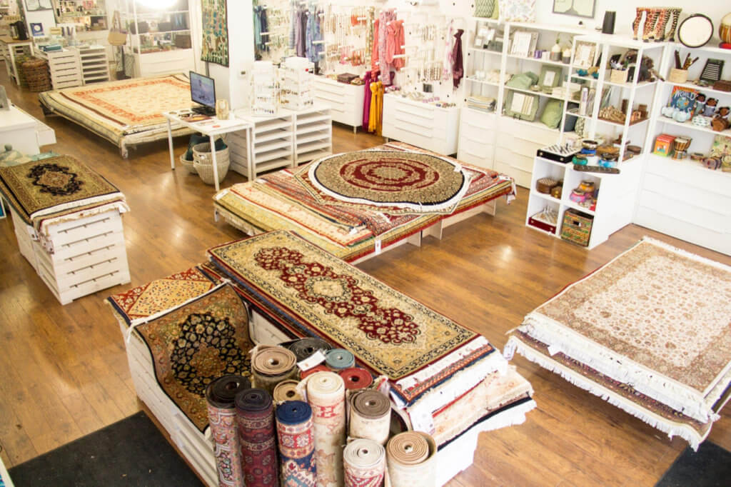 Handmade rugs fill the Ten Thousand Villages Waterloo showroom in May 2018