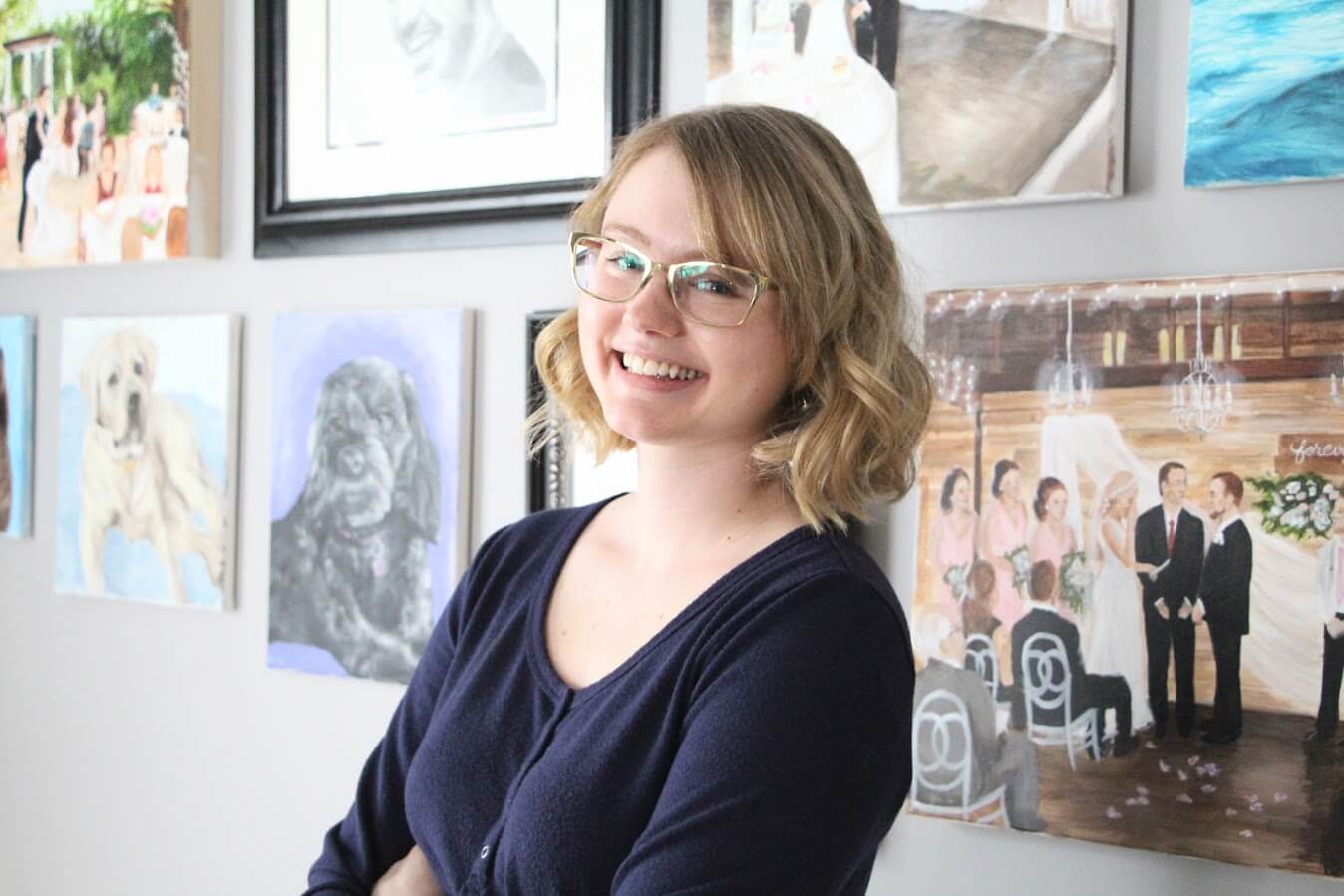 Live event painter Emily McDougall poses with her art.