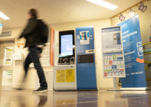 A student walks by a SpotRx pharmacy on Conestoga College's Doon Campus.