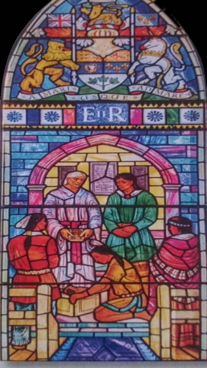A stained glass window in the Royal Mohawk Chapel, featuring five Indigenous figures, one of whom is John Norton holding the gospel he translated