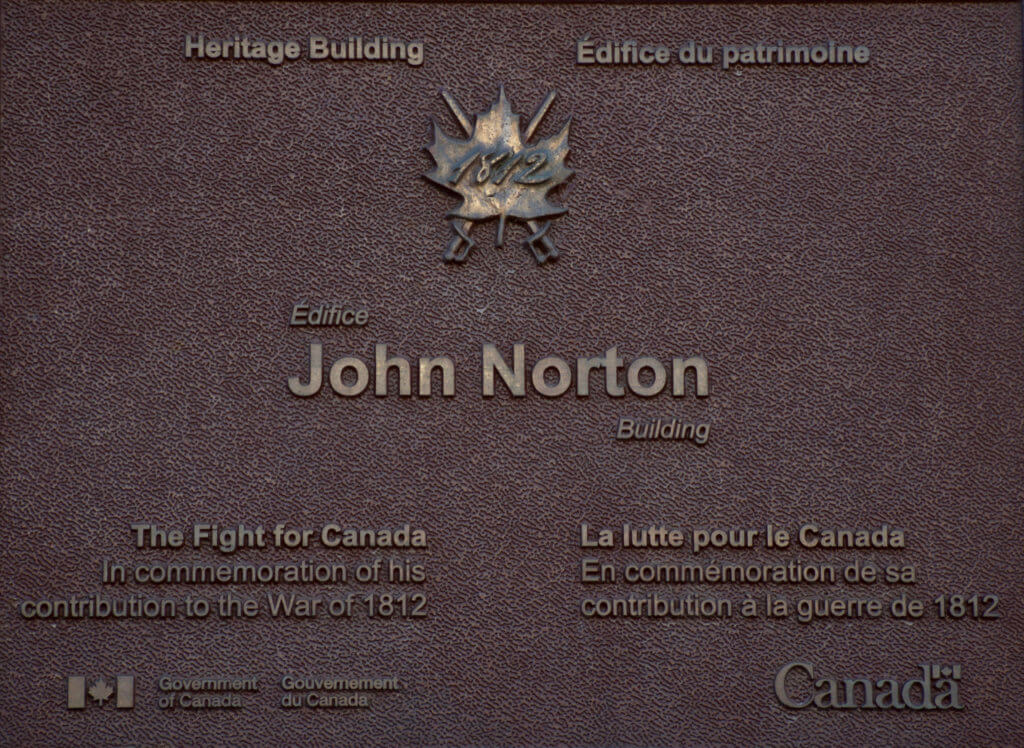 The plaque on the John Norton building.