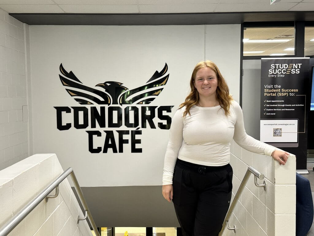 A photo of Ellis in front of the Conestoga Condor's Cafe logo, taken on September 15, 2025. Photo by John Dalusong